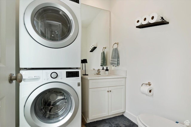 6216 W Birch Run Rd S, South Jordan, UT 84009 - washroom with baseboards, stacked washer / drying machine, a sink, and laundry area