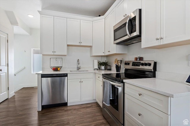 6216 W Birch Run Rd S, South Jordan, UT 84009 - kitchen with dark wood-style flooring, appliances with stainless steel finishes, a sink, light countertops, and white cabinetry