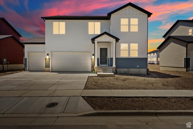 3461 S 3100 W Unit 175, West Haven, UT 84401 - view of front facade with driveway, board and batten siding, a garage, and an attached garage