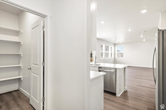 3461 S 3100 W Unit 175, West Haven, UT 84401 - kitchen with stainless steel appliances, wood finished floors, light countertops, recessed lighting, and a peninsula