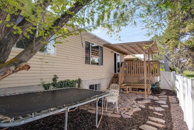 9745 S Tayside Dr W, South Jordan, UT 84009 - view of side of property with a trampoline, a fenced backyard, a wooden deck, a patio, and a pergola