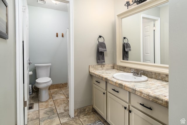 9745 S Tayside Dr W, South Jordan, UT 84009 - bathroom featuring vanity, stone finish flooring, and toilet