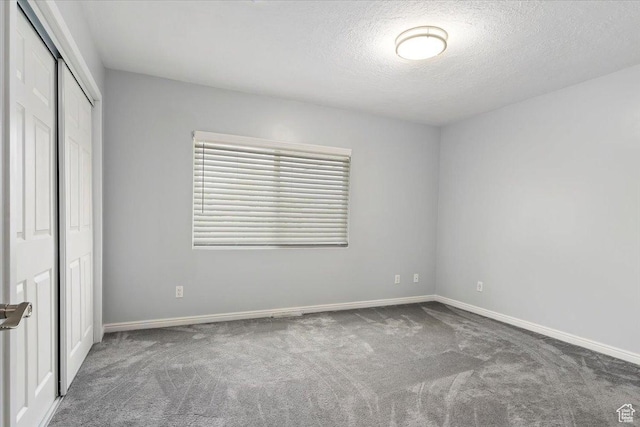 4612 S 600 E, Murray, UT 84107 - unfurnished bedroom with baseboards, carpet, a closet, and a textured ceiling