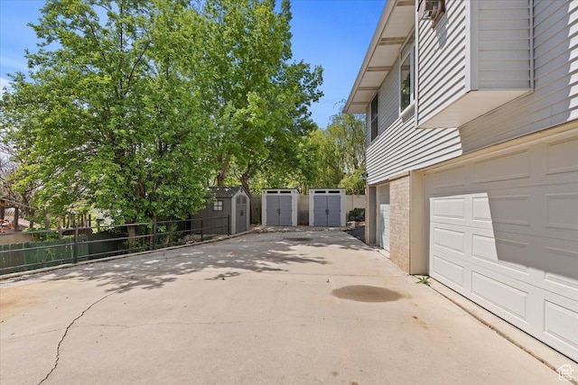 4612 S 600 E, Murray, UT 84107 - view of home's exterior with fence, a garage, a shed, an outbuilding, and driveway