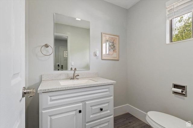 4612 S 600 E, Murray, UT 84107 - half bathroom with vanity, baseboards, wood finished floors, and toilet