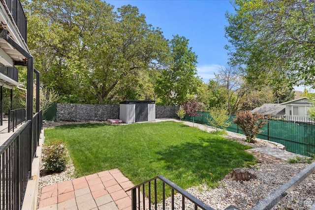 4612 S 600 E, Murray, UT 84107 - view of yard with an outdoor structure, a fenced backyard, and a shed