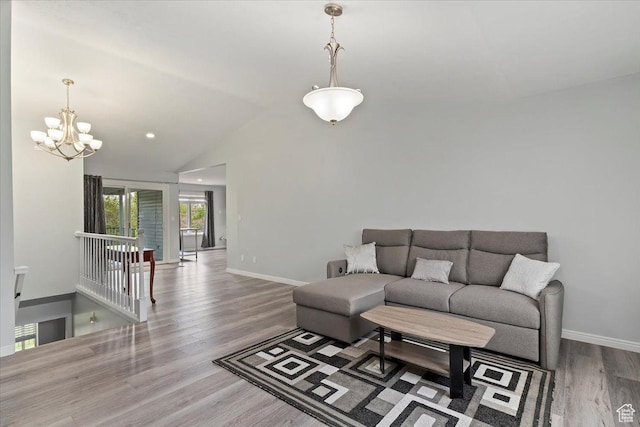 4612 S 600 E, Murray, UT 84107 - living room with baseboards, vaulted ceiling, wood finished floors, and a notable chandelier