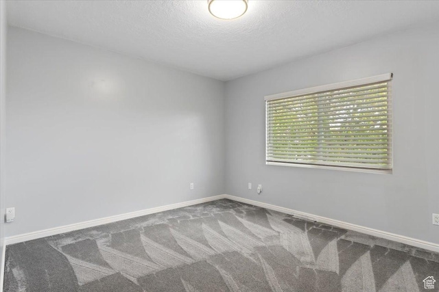 4612 S 600 E, Murray, UT 84107 - unfurnished room featuring baseboards, a textured ceiling, and carpet