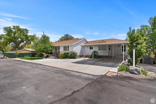 4612 S 600 E, Murray, UT 84107 - single story home with an outdoor structure, fence, stucco siding, concrete driveway, and a storage shed