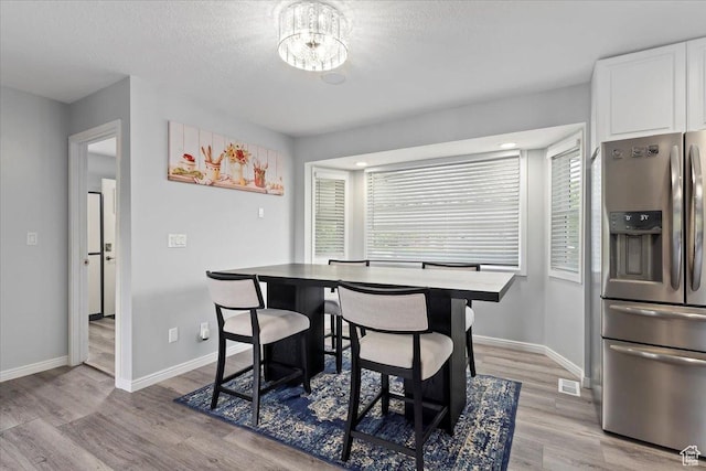 4612 S 600 E, Murray, UT 84107 - dining room with baseboards, visible vents, and light wood finished floors