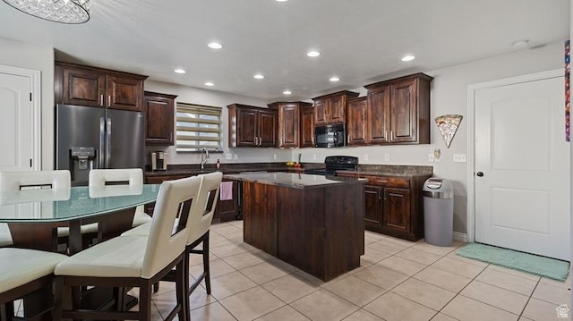2077 N 1450 W, Clinton, UT 84015 - kitchen with light tile patterned flooring, a kitchen island, dark brown cabinets, recessed lighting, and black appliances