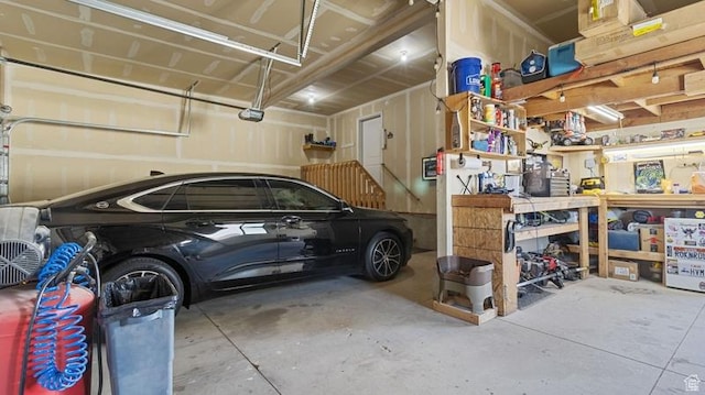 2077 N 1450 W, Clinton, UT 84015 - garage featuring a workshop area and a garage door opener