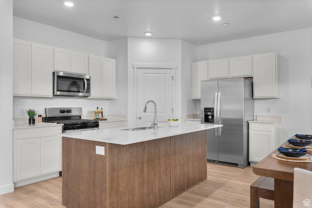 796 N 1860 E Unit 164, Salem, UT 84653 - kitchen with a center island with sink, light countertops, a sink, light wood finished floors, and stainless steel appliances