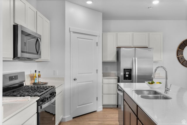 796 N 1860 E Unit 164, Salem, UT 84653 - kitchen featuring a sink, light wood finished floors, light countertops, stainless steel appliances, and white cabinetry