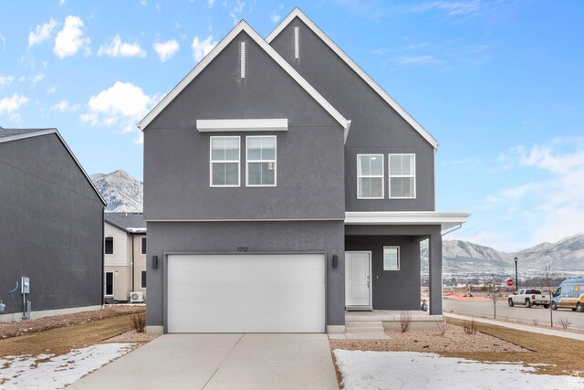 796 N 1860 E Unit 164, Salem, UT 84653 - view of front of home featuring covered porch, a mountain view, concrete driveway, an attached garage, and stucco siding