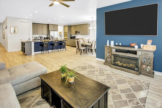6264 W Antelope Flat Way S, Herriman, UT 84096 - living room with baseboards, light wood finished floors, and ceiling fan