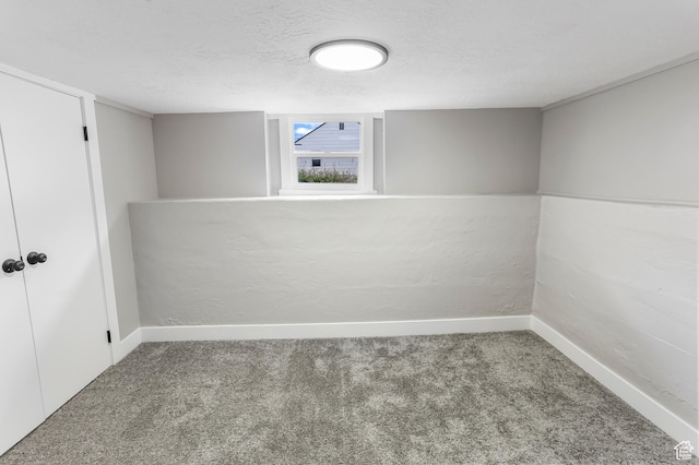 987 S Jefferson Ave E, Ogden, UT 84404 - below grade area with carpet floors, a textured ceiling, and baseboards