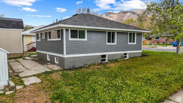 987 S Jefferson Ave E, Ogden, UT 84404 - view of property exterior with a yard, a mountain view, and roof with shingles