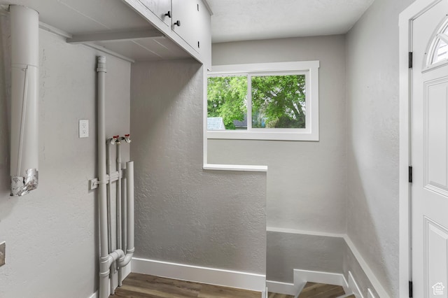 987 S Jefferson Ave E, Ogden, UT 84404 - laundry area with cabinet space, baseboards, a textured wall, and wood finished floors