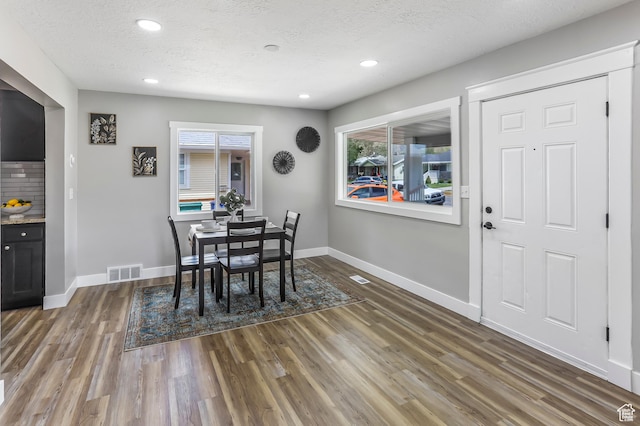987 S Jefferson Ave E, Ogden, UT 84404 - dining room with visible vents, baseboards, a textured ceiling, and wood finished floors