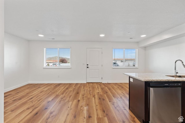 468 W Main St, Santaquin, UT 84655 - kitchen with light stone countertops, a sink, light wood finished floors, baseboards, and stainless steel dishwasher