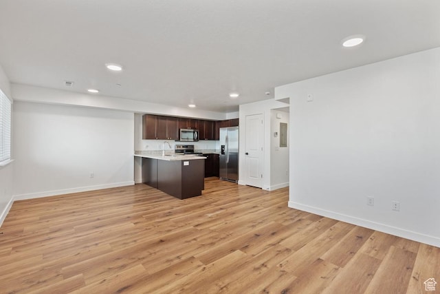 468 W Main St, Santaquin, UT 84655 - kitchen featuring dark brown cabinets, appliances with stainless steel finishes, light countertops, a peninsula, and open floor plan
