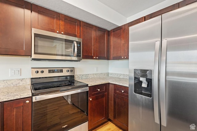 468 W Main St, Santaquin, UT 84655 - kitchen with light stone countertops, appliances with stainless steel finishes, and light wood-style flooring