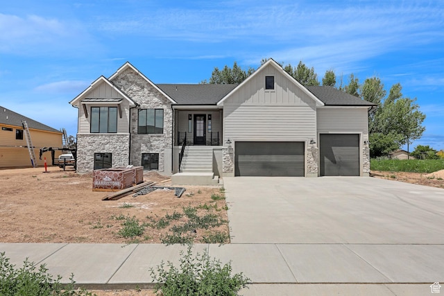 2881 N 3475 W Unit 17, Plain City, UT 84404 - view of front of home featuring board and batten siding, stone siding, driveway, and a garage