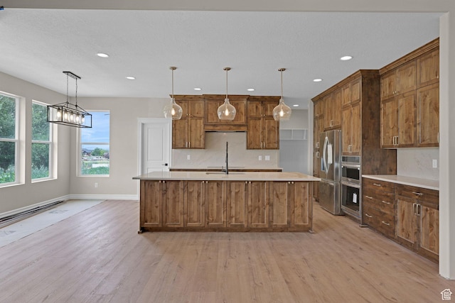2881 N 3475 W Unit 17, Plain City, UT 84404 - kitchen featuring stainless steel appliances, light wood-style floors, light countertops, recessed lighting, and backsplash