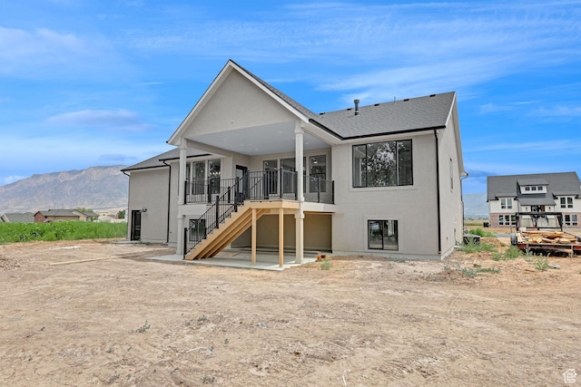 2881 N 3475 W Unit 17, Plain City, UT 84404 - rear view of property with stairs, a mountain view, a shingled roof, and stucco siding