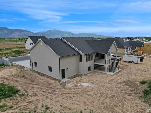 2881 N 3475 W Unit 17, Plain City, UT 84404 - back of property with a mountain view, stucco siding, a shingled roof, and stairway
