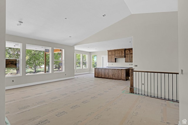 2881 N 3475 W Unit 17, Plain City, UT 84404 - unfurnished living room featuring baseboards and high vaulted ceiling