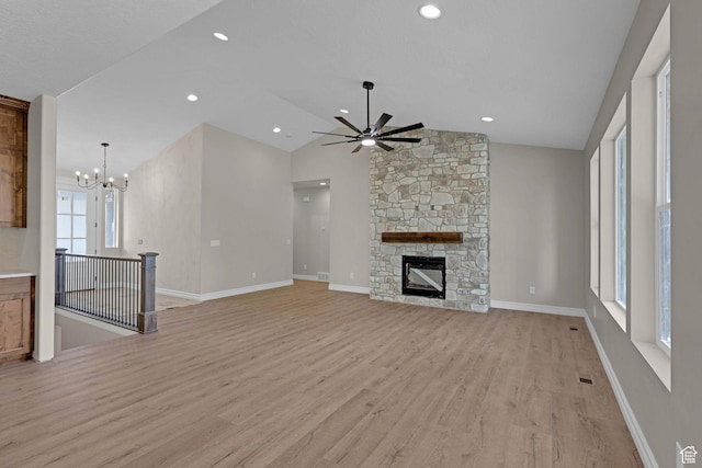 2881 N 3475 W Unit 17, Plain City, UT 84404 - unfurnished living room featuring light wood-style flooring, a ceiling fan, lofted ceiling, a fireplace, and a chandelier