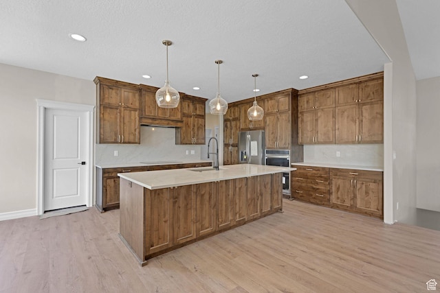 2881 N 3475 W Unit 17, Plain City, UT 84404 - kitchen featuring stainless steel fridge with ice dispenser, light wood-type flooring, a center island with sink, light countertops, and recessed lighting