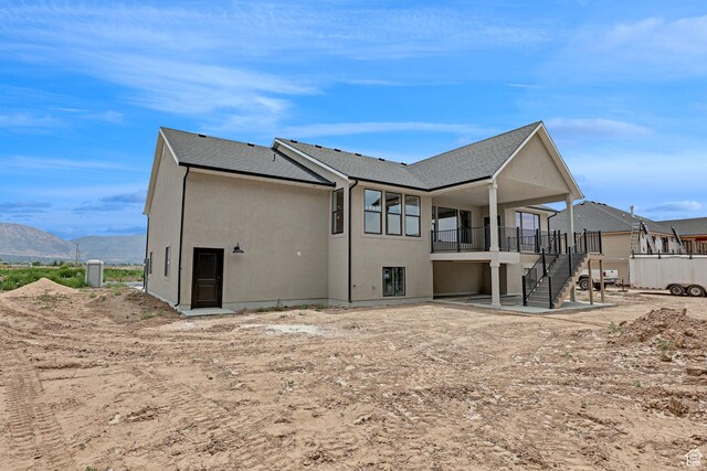 2881 N 3475 W Unit 17, Plain City, UT 84404 - back of property featuring stairs, a mountain view, stucco siding, and a shingled roof