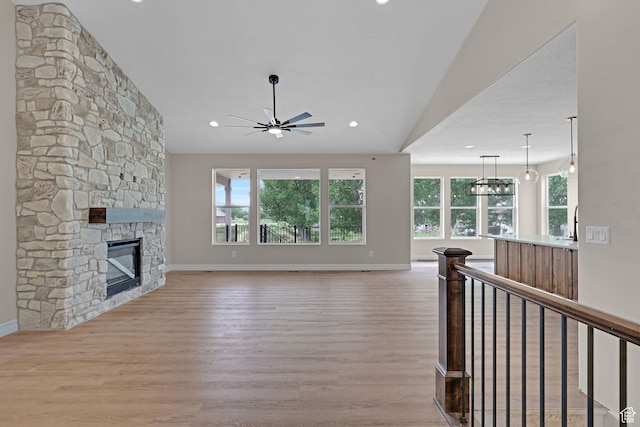 2881 N 3475 W Unit 17, Plain City, UT 84404 - living area with a ceiling fan, wood finished floors, a stone fireplace, and recessed lighting