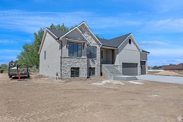 2881 N 3475 W Unit 17, Plain City, UT 84404 - view of front of property featuring a garage, board and batten siding, driveway, and stone siding