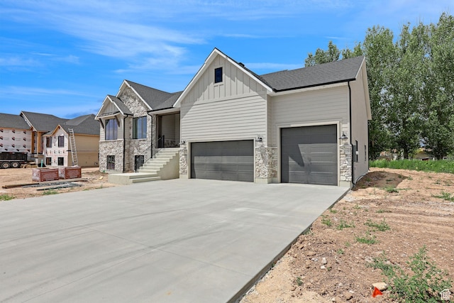 2881 N 3475 W Unit 17, Plain City, UT 84404 - view of front of property with board and batten siding, an attached garage, driveway, and stone siding