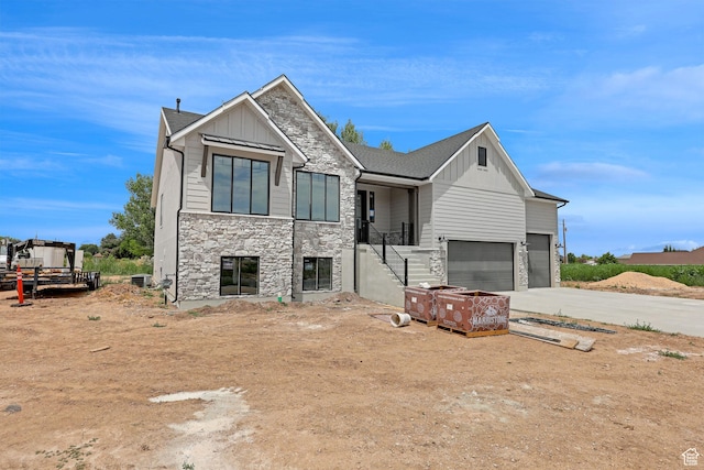 2881 N 3475 W Unit 17, Plain City, UT 84404 - contemporary home featuring board and batten siding, stone siding, a garage, and concrete driveway