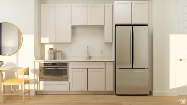 590 S Cecita Way, St George, UT 84770 - kitchen with a sink, freestanding refrigerator, light wood-type flooring, and oven