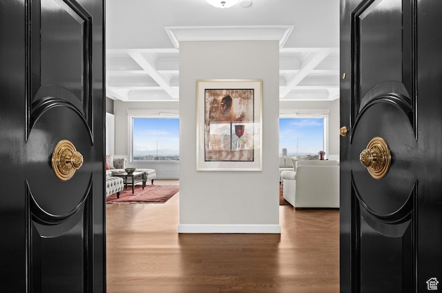 hallway featuring beamed ceiling, baseboards, wood finished floors, and coffered ceiling