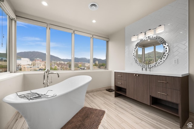 1235 E 200th St S Unit 1001, Salt Lake City, UT 84102 - full bathroom featuring recessed lighting, a mountain view, a soaking tub, and vanity