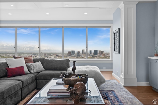 1235 E 200th St S Unit 1001, Salt Lake City, UT 84102 - living room featuring baseboards, decorative columns, a wealth of natural light, and wood finished floors