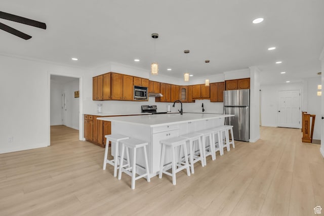 kitchen featuring light countertops, brown cabinets, stainless steel appliances, and recessed lighting