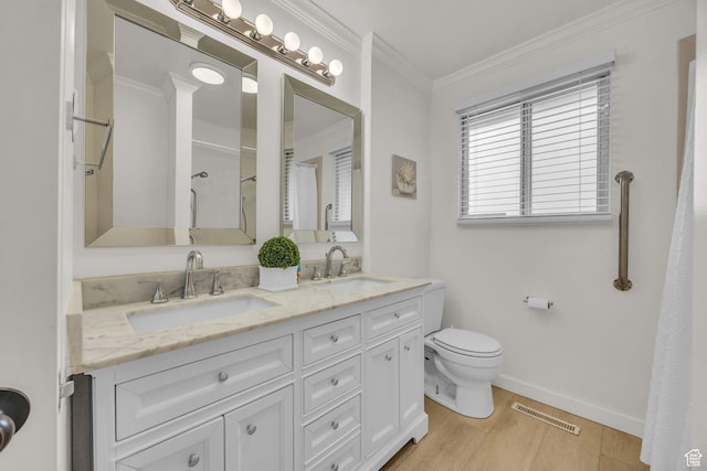 full bathroom with a sink, toilet, wood finished floors, and visible vents