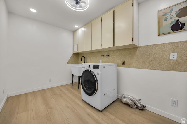 laundry room featuring cabinet space, baseboards, light wood finished floors, washer / dryer, and recessed lighting