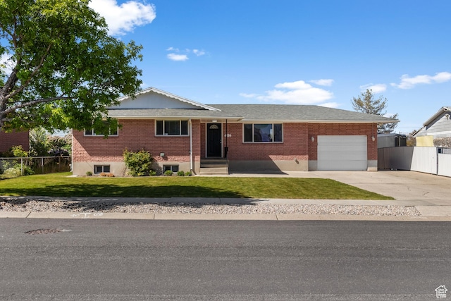 4204 W 4495 S, West Valley City, UT 84120 - single story home featuring an attached garage, a front lawn, fence, and brick siding