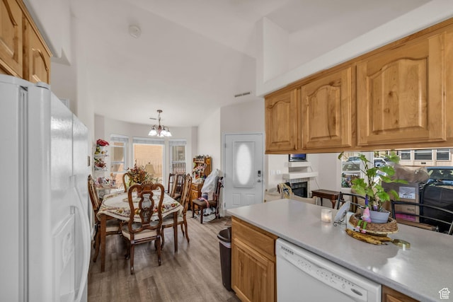 2990 E Riverside Dr Unit 118, St George, UT 84790 - kitchen featuring visible vents, white appliances, light countertops, a chandelier, and light wood-style flooring