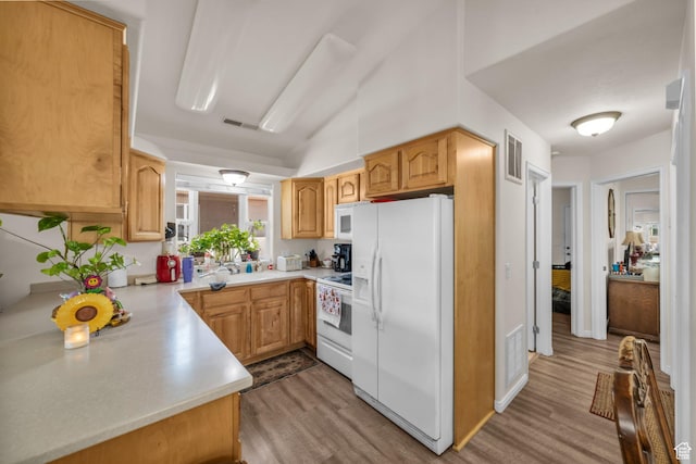 2990 E Riverside Dr Unit 118, St George, UT 84790 - kitchen featuring white appliances, visible vents, wood finished floors, and light countertops