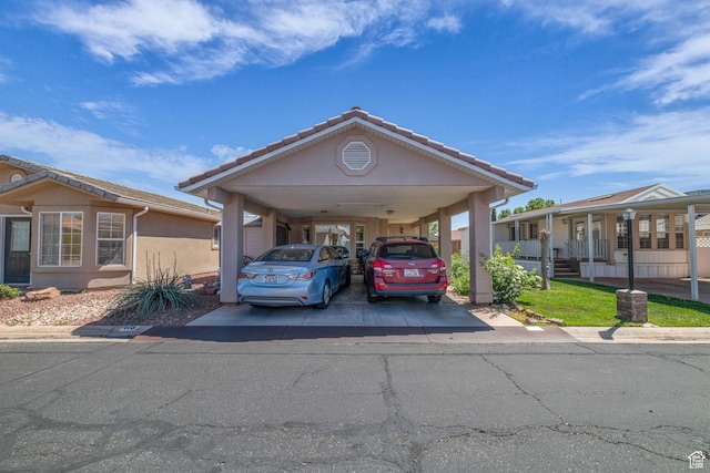 view of vehicle parking with a carport